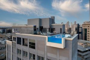 a building with a swimming pool on top of it at Hotel Indigo Tel Aviv - Diamond District, an IHG Hotel in Tel Aviv