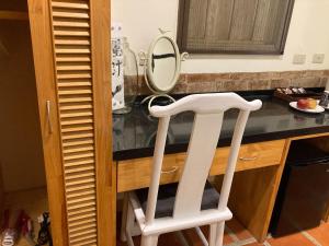 a white stool in a kitchen with a mirror at Shenten Homestay in Jincheng +32 photos
