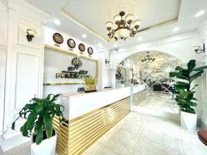 a lobby of a store with plants and a chandelier at Phuong Vy Luxury Hotel in Da Lat