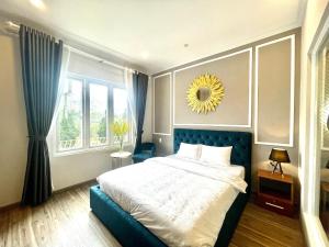 a bedroom with a large bed and a large window at Phuong Vy Luxury Hotel in Da Lat