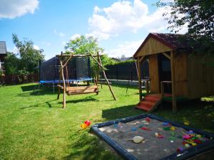 a playground with a trampoline and a swing at Pokoje Gościnne "Keja" in Dąbki