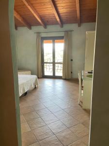 a room with a bed and a table and a window at Agriturismo San Giovanni in Olbia