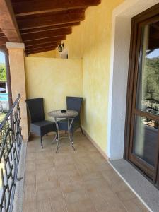 a patio with a table and chairs on a balcony at Agriturismo San Giovanni in Olbia