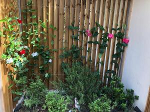 a wooden fence with flowers and plants at La Verda in Bonifacio
