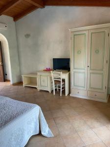 a bedroom with a desk and a bed and a table at Agriturismo San Giovanni in Olbia