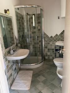 a bathroom with a shower and a sink and a toilet at Agriturismo San Giovanni in Olbia