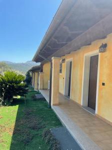 a row of buildings with their doors open on a lawn at Agriturismo San Giovanni in Olbia