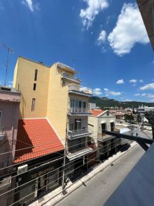 a view of a building from a balcony at COZY DOWNTOWN APARTMENT in Xanthi