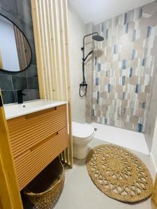 a bathroom with a sink and a toilet and a mirror at Casa del palmar suite in Valencia