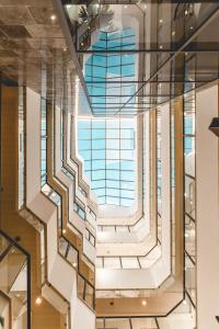 a spiral staircase in a building with a large window at Emily's Hotel in Tiberias