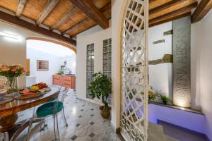 a kitchen and dining room with a wall of windows at Il Giardino Fiorentino - Luxury Apartment & Spa in Florence