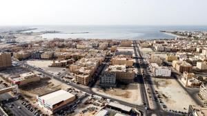 an aerial view of a city with the ocean at Maskan Almadinah in Dammam