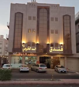 budynek z samochodami zaparkowanymi przed nim w obiekcie فندق السد الخليجى w mieście Sīdī Ḩamzah