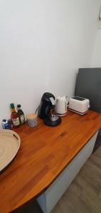 a wooden counter top with two toasters on it at Beau T2 en centre ville avec place de parking auto vélo in Blois