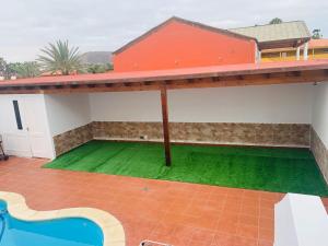 a view of a house with a green lawn at Lin House in Corralejo