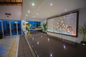 a large screen in a room with a large aquarium at Splash Inn Nuevo Vallarta & Parque Acuatico in Nuevo Vallarta