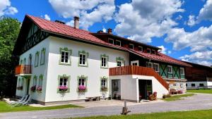 a large white building with a red roof at De Nussi's Chalet 4 in Bach