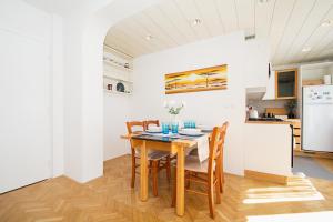 een keuken en eetkamer met een houten tafel en stoelen bij Family Apartment Magnolia - Free Private Parking in Ljubljana