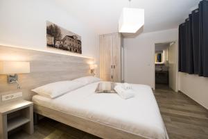 Postel nebo postele na pokoji v ubytování Villa Pellio Apartmani