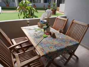 a table with two chairs and a table with flowers on it at GARDEN 128 in Corralejo