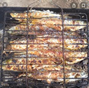 a bunch of food cooking on a grill at jardin de raisin in Bouznika