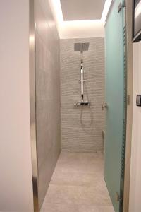 een badkamer met een douche en een glazen deur bij Athelia Athens in Athene