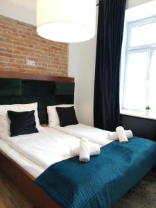 a large bed with two pillows on top of it at Rooms by Apartamenty Lubartowska Street in Lublin