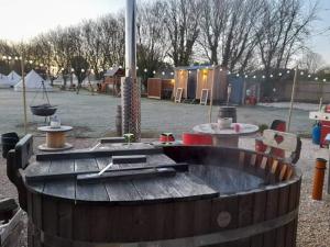 a playground with a wooden table in a park at Angela's Rest Shepherds Hut with Scandi Hot Tub in Boston +5 photos