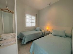 Posteľ alebo postele v izbe v ubytovaní El Sabor del Sur, Apartamentos Living Sur