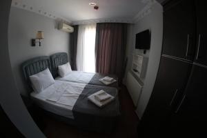 Postel nebo postele na pokoji v ubytování Ares Hotel