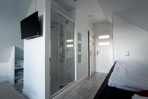 a bedroom with a glass shower and a bed at Agroturystyka ''Relax'' in Chęciny