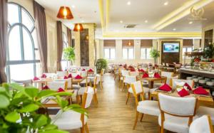 a restaurant with tables and chairs with red napkins at Putin Hotel Nha Trang in Nha Trang