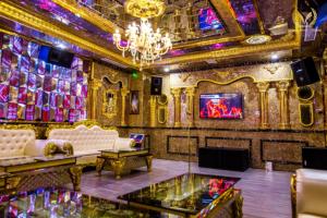 a room with a couch and a chandelier at Putin Hotel Nha Trang in Nha Trang