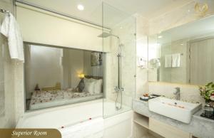 a bathroom with a tub and a sink and a shower at Putin Hotel Nha Trang in Nha Trang