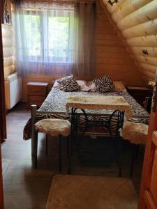 a bedroom with a bed in a log cabin at Wynajem Pokoi Krystyna Mróz in Zakopane