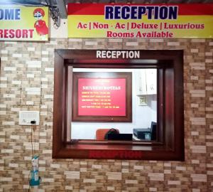 a mirror in a room with a sign on the wall at Shivneri Holiday Resort in Mahabaleshwar