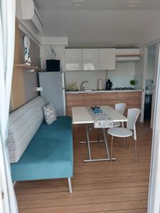 a small kitchen and dining room with a table and chairs at Philomena Mobile home Camping Pasman in Pašman