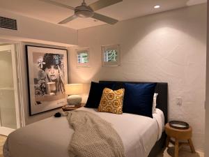 a bedroom with a large bed with blue pillows at Carramah Noosa Heads apartment in Noosa Heads