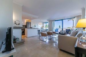 salon z kanapą i telewizorem oraz kuchnia w obiekcie 75-Apartment with Views in Elviria, Marbella w Marbelli