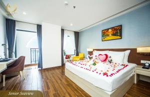 a hotel room with a bed with a heart on it at Putin Hotel Nha Trang in Nha Trang