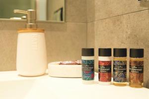 three bottles of hair products sitting on a bathroom counter at Athelia Athens in Athens