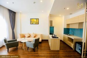 a living room with a couch and a kitchen at Putin Hotel Nha Trang in Nha Trang