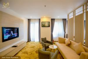 a living room with a couch and a tv at Putin Hotel Nha Trang in Nha Trang