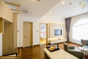 a living room with a couch and a television at Putin Hotel Nha Trang in Nha Trang