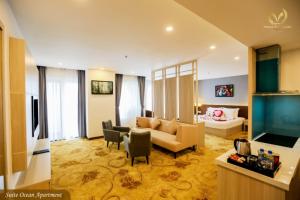 a living room with a couch and chairs and a television at Putin Hotel Nha Trang in Nha Trang