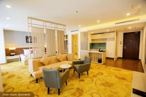 a living room with a couch and chairs and a kitchen at Putin Hotel Nha Trang in Nha Trang