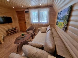 a living room with a couch and a table at Hedonist Village in Žabljak