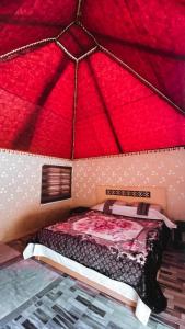 a model of a bedroom with a red roof at Wadi Rum Nature Tours And Camp in Wadi Rum