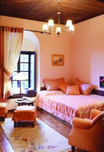 a bedroom with a bed and a large window at Santikos Mansion in Vizitsa