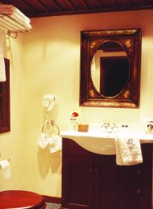 a bathroom with a sink and a mirror on the wall at Santikos Mansion, Santikos Collection in Vyzitsa +18 photos